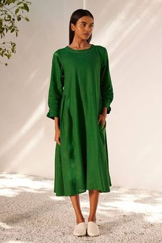 Forest green midi dress with gathers on the sides and smocking detail on the sleeves.
Components: 1
Pattern: Embroidered
Type Of Work: Running Stitches
Neckline: Round
Sleeve Type: Long
Fabric: Linen
Color: Green
Other Details: 
Embroidered neckline
Side seam pockets
Closure: Back zipper
Occasion: Resort,Party - Aza Fashions Green Ruched Maxi Dress For Fall, Green Maxi Dress With Gathered Sleeves, Green Ruched Midi Dress For Fall, Green Long Sleeve Dress With Smocked Cuffs, Summer Green Dress With Elastic Sleeves, Casual Dark Green Midi Dress For Spring, Casual Green Dress With Elastic Sleeves, Green Ruched Midi Dress, Green Relaxed Fit Dress For Fall