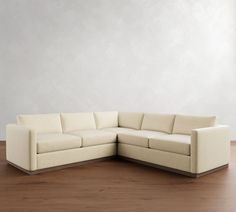 a white couch sitting on top of a wooden floor