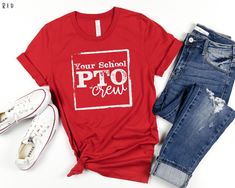 a t - shirt that says your school pto crew next to jeans and sneakers