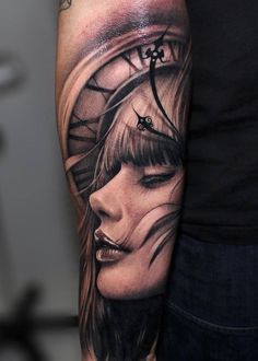 a woman's face and clock tattoo on the arm