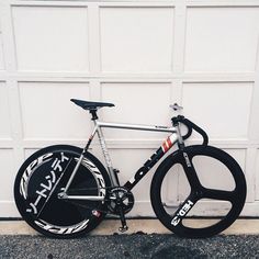 a bicycle parked in front of a garage door