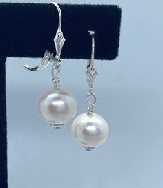 Symbol of beauty, purity, wealth, power and love , pearls fascinate us by their elegance and refinement. The very high luster on this pearl really has that WOw effect! Tone of white glow as the light hits the pearl. This the natural color of this pearl.  The color is soft and elegant and would be perfect for brides, bridesmaids or even a crisp addition to a modern outfit. Matched freshwater Pearls in white sit on sterling silver ear wires to create classic pearl earrings. Pearl size: 10.5mm-11mm Classic Bridal Drop Earrings, Classic Pearl Drop Jewelry, Pear-shaped Pearl Drop Bridal Earrings In White Gold, Elegant Hypoallergenic Sterling Silver Jewelry, Classic Hypoallergenic Dangle Jewelry, Elegant Hypoallergenic Jewelry, Silver Elegant Pearl Earrings For Anniversary, Elegant Silver Bridal Earrings With Pearl Charm, Formal Pearl Pendant Earrings