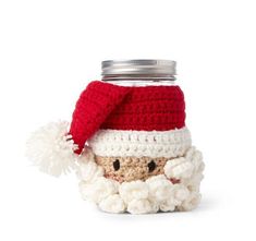 a crocheted santa clause jar with a red and white knitted hat on top