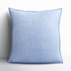 a blue pillow sitting on top of a white table