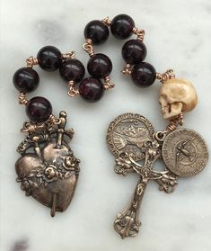 Memento Mori Immaculate Heart, Saint Benedict and Holy Spirit pocket rosary  8mm garnet gemstone beads Ox bone skull 20 gauge solid bronze wire, chain and jump rings bronze medals Memento Mori Rosary, Rosaries Aesthetic, Goth Accessories Jewellery, Bone Rosary, Memento Mori Coin, Bronze Accessories, Pocket Rosary, Immaculate Heart, Decade Rosary