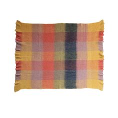 a multicolored plaid pillow with fringes on the front and back side, against a white background