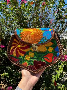 Beautiful colorful Hand Embroidered Mexican Flower Bag made in Chiapas, Mexico. Each bag is hand embroidered and flower will vary but each one is beautiful and unique Adjustable Strap 7" Tall 8" Wide Spring Multicolor Shoulder Bag With Floral Embroidery, Multicolor Floral Embroidered Shoulder Bag For Travel, Multicolor Floral Embroidery Shoulder Bag For Travel, Bohemian Multicolor Floral Print Bag, Multicolor Flower Shaped Shoulder Bag For Travel, Multicolor Hand Tooled Travel Bags, Spring Festival Embroidered Bags, Flower Shaped Multicolor Travel Shoulder Bag, Spring Multicolor Floral Embroidered Shoulder Bag