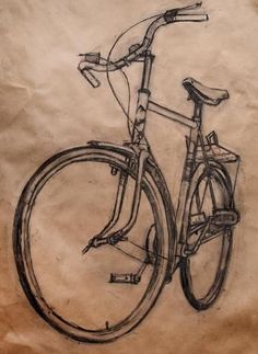 a drawing of a bicycle is shown on a piece of brown paper with black ink