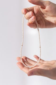 Handcrafted minimalist necklace with delicate natural freshwater pearls and four 925 silver beads or three gold filled beads. Length: 36 cm + 6 cm chain extension (total 42cm) Bead size: 3 mm pearls. Colour: ivory and silver/gold. Each bead is unique. Colour and size may vary slightly from what is shown and the photo, unfortunately, does not show the beauty of the stones. Our packaging consists of a small handmade reusable bag made of sustainable cotton ready to gift and protects jewellery from Necklace Layering, Pearl Choker Necklace, Layering Necklace, Pearl Choker, Minimalist Necklace, Reusable Bags, Wedding Necklace, Gold Beads, Silver Beads