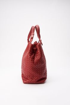 A beautiful vintage red Bottega Veneta Intrecciato leather shoulder bag. When translated to English, intrecciato literally means braided. Bottega Veneta's staple technique involves strips of leather that are intertwined to create a woven pattern, which has become synonymous with the brand. Intrecciato Weave was introduced in the early 1970s and was first used on the brand's handbags. This style is in very good condition both inside and out. Inside this bag is lined with a beautiful suede lining. Height: 27cm. Width: 34cm. Depth: 14cm Strap drop: 13cm To ensure you’re completely satisfied with your purchase, please refer to the images for the exact condition of the item. Vintage Bottega Veneta, Vintage Bottega, Bottega Veneta Intrecciato, Woven Pattern, Louis Vuitton Shoulder Bag, Branded Handbags, Bottega Veneta, Leather Tote, Leather Shoulder Bag