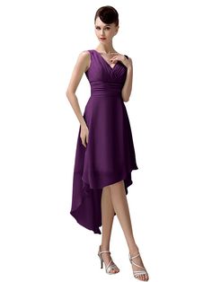 a woman in a purple dress is posing for the camera with her hands on her hips