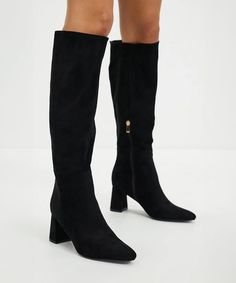 Step up your style game with the Maddison Tall Boot in black suede. These boots are made for walking (and turning heads) with their sleek design and high-quality material. Whether you're dressing up for a night out or keeping it casual, the Maddison Tall Boot has got you covered. faux suede color: black rounded pointed toe pull-on style with inside ankle zip approx 2" heel Trendy Wide Calf Suede Boots, Trendy Suede Knee-high Boots, Trendy Suede Wide Calf Heeled Boots, Trendy Knee-high Suede Boots, Winter Suede Heeled Boots With Suede Lining, Black Suede Heeled Boots For Winter, Trendy Suede Boots For Workwear, Winter Suede Knee-high Heeled Boots, Suede Knee-high Heeled Boots For Winter