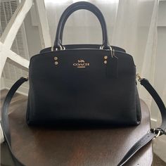 Used A Few Times. Looks Brand New. Designer Black Satchel With Detachable Handle, Classic Black Handheld Satchel, Designer Black Satchel With Double Handle, Luxury Black Satchel With Removable Pouch, Black Top Handle Satchel With Handles, Classic Black Satchel Bag, Black Top Handle Satchel With Gold-tone Hardware, Classic Black Crossbody Satchel, Classic Black Satchel With Top Handle