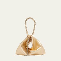 Jimmy Choo "Callie" top handle bag in metallic leather and brass  Chain top handle loops through metal ring with tassel, 3.5"L Zip top closure  Approx. 7.9"H x 9.4"W x 1.4"D Item Weight (Lbs.): 0.7 Made in Italy Jimmy Choo Gold, Leather And Brass, Chain Top, Gold Bag, Metal Ring, Brass Chain, Handle Bag, Metallic Leather, Zip Top