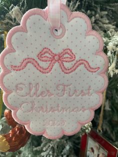 a pink ornament hanging from a christmas tree