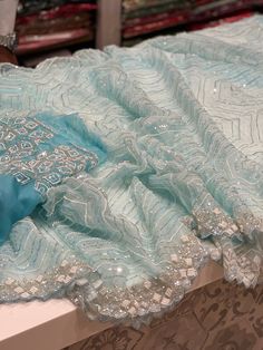 Blue Organza Saree with Moti Sequins Hand Work and a Belt Blue Traditional Wear With Intricate Embroidery For Party, Blue Party Wear Traditional Outfit With Intricate Embroidery, Blue Party Wear Traditional With Intricate Embroidery, Blue Party Wear Sets With Intricate Embroidery, Blue Embroidered Party Wear Dupatta, Blue Embroidered Party Wear Sets, Blue Embroidered Dupatta For Party, Blue Chikankari Embroidered Georgette Fabric, Festive Light Blue Sharara With Intricate Embroidery