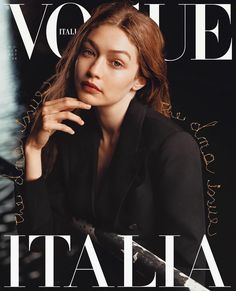 a woman sitting on top of a magazine cover with her hand under her chin and looking at the camera