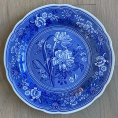 a blue and white plate with flowers on it