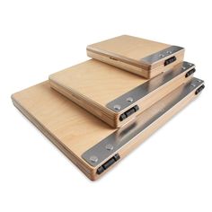 three wooden trays with metal handles are stacked on top of each other