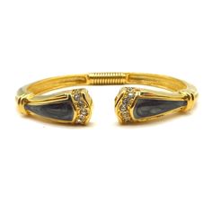 This is a vintage Kenneth Jay Lane for Avon Black and Gold Tone Open Cuff Bangle, studded with bright clear rhinestones on each end.   * The bracelet measures 6-1/4" around (inside measurement) * With a spring to open up the cuff * Signed "KJL for Avon" * This bracelet is in very good condition https://etsy.me/3wgGm9m to view my bracelet collection Black Bangle, Open Cuff Bracelet, Enamel Bangle, Open Bangle, Cuff Bangle Bracelet, Gold Cuffs, Bracelet Black, Rhinestone Studs, Gorgeous Bracelet