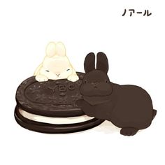 two bunnies are sitting next to each other on a plate with an animal in the middle