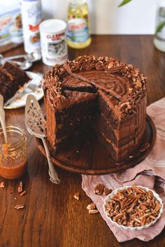 a chocolate cake on a wooden table with one slice cut out