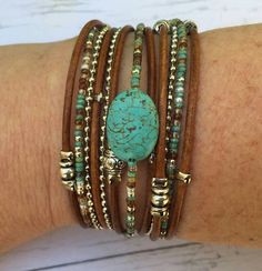 This unique turquoise wrap bracelet was designed to complete your look with a statement.  Combine this with any outfit to give it a unique touch of color that will make you stand out in any event or occasion. FEATURES: *2 cords of distressed honey brown genuine leather *1 antique silver mini ball chain *1 hand beaded strand of Miyuki (Japanese Glass) Beads in earth tone colors *1 Turquoise Howlite Oval Bead (1 3/4 x 1 1/4 Cm) *Tibetan Beads *Four Charms of Your Choice *Silver tone lobster clasp Turquoise Wrap Bracelet, Wrap Armband, Look Festival, Engraved Cuff, Boho Wrap Bracelet, Personalized Leather Bracelet, Spring Bracelet, Fashion Festival, Wrap Bracelets