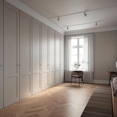 an empty bedroom with wooden floors and white walls, along with large closets in the corner