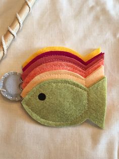 a small felt fish on a white surface