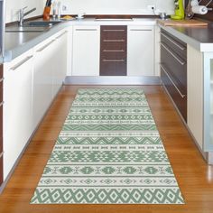 a kitchen with wooden floors and white cabinets