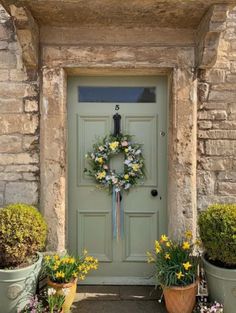 the front door is decorated with flowers and wreaths