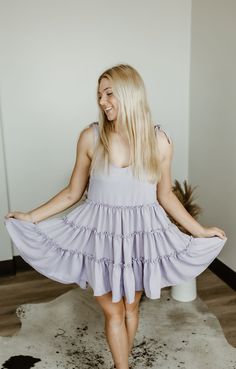 Step into carefree vibes with the Sundown Serenade Tiered Babydoll Dress. Made from textured crepe fabric, this boho-inspired dress features tiered ruffles for a playful, flowy silhouette that dances with every step. The adjustable tie straps allow for a customizable fit, making it perfect for sunny beach days or warm nights out. With its wide bottom sweep, this dress adds an effortlessly feminine touch to any occasion. Whether you're strolling through a farmers' market or heading to a casual su Tiered Ruffle Dress For Vacation, Breezy Dress With Ruffled Straps For Brunch, Breezy Brunch Dress With Ruffled Straps, Tiered Ruffle Hem Sundress For Brunch, Tiered Sundress With Ruffle Hem For Brunch, Tiered Dress With Ruffle Hem And Straps For Summer, Casual Tiered Mini Dress For Garden Party, Spring Tiered Sundress, Cute Tiered Ruffled Mini Dress