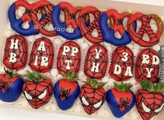 spiderman birthday cookies in a box with strawberries and pretzels