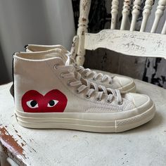 Wear Your Heart On Your Shoes With The Converse X Comme Des Garons Play Chuck 70 Sneaker. This Street-Ready Style Features The Premium Chuck Details You Know And Love, Paired With A Whimsical Heart-And-Eyes Graphic Peeking Just Above The Sole. Eye-Catching Is An Understatement. Why You Should Be Down: -Canvas Is Lightweight And Durable. -Tonal Rubber Toe Cap And Contrasting Heelstay For Standout Style. -Lace-Up Design For A Snug Fit. -Vulcanized Rubber Sole For Increased Traction. -Signature Hea Streetwear High-top Sneakers With Vulcanized Sole, Flat Canvas Sneakers With Vulcanized Sole, Flat Vulcanized Canvas Sneakers, Canvas Sneakers For Streetwear With Flat Heel, Flat Canvas Sneakers For Streetwear, Casual Slip-on Sneakers With Medium Fit, Casual Medium Fit Slip-on Sneakers, Converse Sneakers With Vulcanized Sole And Round Toe, Converse Sneakers With Vulcanized Sole