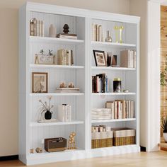 a white book shelf filled with lots of books next to a potted plant on top of a hard wood floor