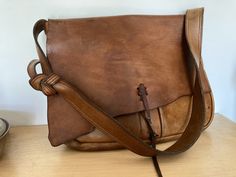 1960s Leather Messenger Bag Briefcase 16" Handmade. Gorgeous thick leather! In excellent condition but obviously older and used...nice patina. Thick raw leather, unlined. Rare find, one-of-a-kind. The color is best shown by some of the darker pictures.  16L x 13T x 2.5-2.8D" Strap Drop 15.5"  Strap Width 1.75W' at widest Large back outside pocket (14.2W x 9H") Two large outside of front pockets (under flap) Front pocket with snap is 10H x 12W" (opening is about 9.5" snap closure Inside flat pock Vintage Leather Bags With Snap Closure, Vintage Bridle Leather Bag With Leather Lining, Vintage Brown Soft Leather Crossbody Bag, Vintage Oiled Leather Shoulder Bag With Waxed Finish, Vintage Vegetable-tanned Shoulder Bag For Daily Use, Vintage Brown Leather Bag With Zipper Closure, Vintage Brown Shoulder Bag With Waxed Finish, Vintage Brown Bridle Leather Bag, Vintage Brown Vegetable-tanned Shoulder Bag