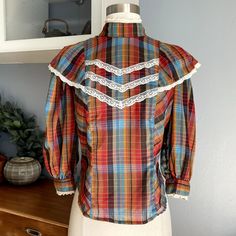 Vintage 80s 70's Plaid Ruffle Shirt Prairie Top Lace Trim Retro Size: M Chest: 37" Length: 22" 3/4 sleeve 65% polyester, 35% cotton Made in California Condition: Great. No rips, stains or holes. Retro Puff Sleeve Tops For Fall, Retro Cotton Blouse With Puff Sleeves, Fall Retro Blouse, Retro Collar Top For Fall, Vintage Multicolor Blouse For Daywear, Vintage Style Multicolor Blouse For Daywear, Vintage Fitted 3/4 Sleeve Tops, Multicolor Vintage Blouse For Daywear, Retro Long Sleeve Ruffled Tops