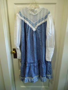 Wonderful find....Rare Gunne Sax Tent dress with high lace neck and pockets on sides between waist and hip. Beautiful floral print, has all of it's original buttons, lovely pouf sleeves that taper at wrists, YKK zipper in excellent condition. The dress still feels brand new, like it was never washed, maybe just tried on. It smells good, like it was folded up carefully in someones dresser drawer for the last 50 years! the only issue I see is there is a little bit of makeup on the inside collar where somebody may have tried it on(see photos of neck...the first one isn't stained...the lace looks a little darker from the makeup possibly showing through..or the thread/stitching...the second photo with my hand shows the actual makeup stain inside the collar.) I did NOT try to treat the stain in Vintage Smocked Fitted Dress, Vintage Smock Dress For Daywear, Fitted Vintage Smock Dress, Fitted Smock Vintage Dress, Prairie Daywear Dresses With Ruffles, Prairie Ruffle Dress For Daywear, Prairie Style Ruffled Dresses For Daywear, Prairie Style Ruffle Dresses For Daywear, Vintage Cotton Dress With Yoke Detail