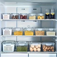 an open refrigerator filled with lots of food and condiments in containers on the shelves