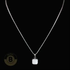 This necklace embodies modern masculinity with a solid chain that oozes power and panache. The square stone pendant? It's a symbol of order, stability, and honesty. This stunner is the perfect blend of ruggedness and refinement for the contemporary gentleman. Specifications: Metal: Stainless SteelFinish: PolishedPendant Weight: 6gPendant: 0.59"x0.59" | 15mmx15mm When it comes to men's necklaces, stainless steel offers strength, shine, and street cred. Stainless Steel necklaces interlock metal ri Modern Necklace With Box Chain And Square Pendant, Elegant Sterling Silver Chain Necklace With Square Pendant, White Gold Jewelry With Rectangular Pendant Box Chain, Formal Square Pendant Box Chain Jewelry, Modern Jewelry With Clavicle Chain And Square Pendant, Formal Box Chain Jewelry With Rectangular Pendant, Formal Jewelry With Box Chain And Rectangular Pendant, Formal Necklace With Rectangular Pendant And Box Chain, Formal Jewelry With Rectangular Pendant And Box Chain