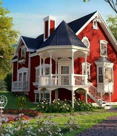 a large red house with white balconies