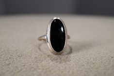 I am offering you this vintage 10 K white gold (stamped) wedding band stacker design ring. It features an oval  shaped bezel set genuine black onyx stone. This stone is set in an amazing single stone classic setting. It is currently a size 5, though I am sure this could easily be sized up or down. It measures app. 3/4 inch.  It weighs app. 2.5 grams.  Please review all of my pictures, as they all an important part of my listing / description This is a must have to add this to your jewelry collection. Buyer pays shipping and handling. Vintage White Gold Oval Cabochon Ring, Victorian Black Enamel Wedding Rings, Vintage Oval Cabochon Signet Ring For Formal Events, Vintage Oval Cabochon Signet Ring For Formal Occasions, Classic Oval Ring With Polished Edges, Classic Oval Black Enamel Ring, Classic Black Enamel Oval Ring, Black Victorian Signet Ring For Wedding, Victorian Black Signet Ring For Wedding