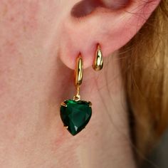 These unique earrings feature 24k gold plated 12mm hoops with a stunning vintage emerald glass heart stone attached at the base. The 12x11mm stones originate from Germany and are estimated to have been created in the 1950s. The stones have been carefully hand set in modern, 24k gold plated settings which allow the stones to be attached to the hoops. Heart Stone, Glass Heart, Stone Heart, The 1950s, Jewelry Tutorials, Unique Earrings, Plate Sets, Emerald, Gold Plate