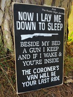 a sign on the side of a tree that says, now i lay me down to sleep