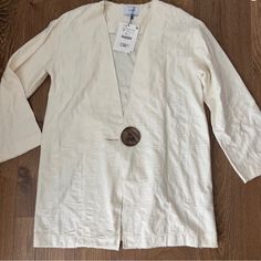 Snag This Amazing, New With Tags, Zara Basic Long Ivory Cardigan From Europe! The Cardigan Has A Really Cool Big Wooden Button As A Feature. Fall/Winter 2018 Collection. Material/Care Instructions In Last Three Pictures. Open To Reasonable Offers... Bundle And We Can Chat About Pricing Privately! Zara V-neck Outerwear With Buttons, Cream Cardigan With Buttons For Spring, Spring Cotton Single-breasted Cardigan, Single Breasted Cotton Button-up Cardigan, White Cotton Button-up Blazer, Summer Cotton Cardigan With Buttons, Button-up Beige Cotton Cardigan, Cream Cotton Button-up Cardigan, Cotton Cardigan With Buttons For Daywear