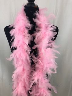 a pink feather scarf on a mannequin