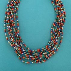 Multi Strand Necklace (10 Strands) Hand Strung Using Premium Seed Beads. Red, Blue, Orange, Pearl, Tan. Lobster Claw Clasp, 2” Extender. Stainless Steel Beadcaps Finish The Ends Of The Strands. Southwestern Multi-strand Large Bead Necklaces, Southwestern Multi-strand Necklaces With Large Beads, Southwestern Multi-strand Jewelry With Colorful Beads, Southwestern Multi-strand Necklace With Large Beads, Southwestern Multi-strand Colorful Beads Jewelry, Multicolor Large Beads Southwestern Jewelry, Multicolor Southwestern Beaded Chain Jewelry, Southwestern Multicolor Beaded Chain Jewelry, Multicolor Southwestern Style Beaded Chain Jewelry