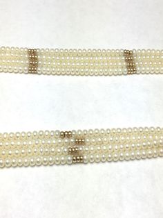 "Four Row Freshwater Pearl and 14K Yellow Gold Beads and Clasp 4 Rows Button Shape Freshwater Pearls Large Spring Ring Clasp measures approx. 6/8\" round Necklace Measures approx. 18 1/2\" long or 46 cm Freshwater Pearls average diameter: 4 mm Pearls are white in color with good luster 84 Gold Beads - Solid 14K Yellow Gold Stamped: \"585\" on clasp Weight: 56 grams Beautiful pearl necklace for a vintage wedding 050516-4257 FEEL FREE TO MESSAGE ME WITH A BEST OFFER OR IF YOU WISH TO SEE MORE PICT Formal Pearl Necklace With Polished Beads, Classic Polished Pearl Necklace For Wedding, Classic Wedding Pearl Necklace With Polished Beads, Classic White Bridal Necklace With 17 Jewels, Yellow Gold Beaded Pearl Necklace For Wedding, Yellow Gold Beaded Pearl Necklace For Formal Occasions, Wedding Yellow Gold Beaded Pearl Necklace, Formal Yellow Gold Beaded Pearl Necklace, Elegant Pearl Necklace With Polished Beads For Wedding