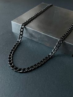 Our stainless steel curb chain is made from premium quality 316L stainless steel. This stunning piece of jewelry is not only made from high-quality stainless steel, but it also features a mesmerizing black finish that will draw attention wherever you go. The classic curb link design adds an extra layer of sophistication to the already unique dark aesthetic of this chain. The chain is durable and made for everyday wear. Stainless steel is hypoallergenic, resistant to tarnishing and waterproof! Ma Cheap Black Chain Necklace For Men, Black Stainless Steel Chain Link Necklace, Black Cuban Link Chain Necklace Gift, Black Metal Curb Chain Necklace, Black Curb Chain Jewelry For Streetwear, Minimalist Black Cable Chain Necklace, Black Cuban Link Stainless Steel Chain Necklace, Black Cuban Link Stainless Steel Necklace, Black Cuban Link Curb Chain Jewelry