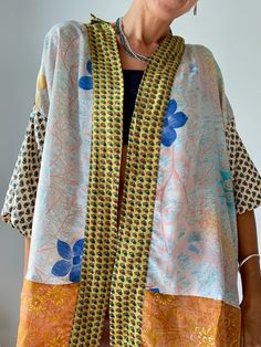 This is very bright and colurful summer free size blouse with wide kimono sleeves,  loose and light, makes very to easy to wear blouse, as a cover up  made in soft silky material, with strong colours, patchwork style,  fits all,  great for summer holiday, vacation, beach or as party outfit free size (plus) Please check also  https://www.etsy.com/shop/AltheaStores? Thank You for looking Lagenlook Patchwork Blouse For Summer, Summer Patchwork Lagenlook Blouse, Summer Floral Print Blouse With Kimono Sleeves, Summer Blouse With Floral Print And Kimono Sleeves, Floral Print Blouse With Kimono Sleeves For Summer, Yellow Bohemian Kimono With Kimono Sleeves, Bohemian Yellow Long Sleeve Kimono, Bohemian Blouse With Vibrant Print For Beach, Oversized Multicolor Summer Blouse